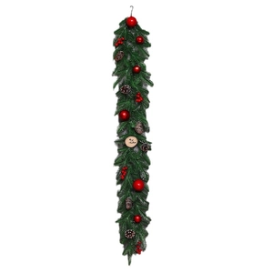 Christmas pine needle garland with red berries, pine cones and Merry Christmas wooden tag