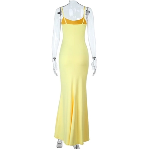 Detail of the back slim fit and fishtail hem on the yellow backless evening dress