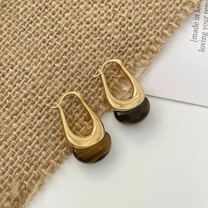 Irregular gold metal hoop earrings with brown tiger eye texture resin pendant