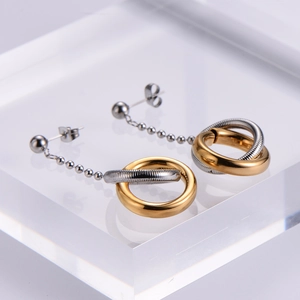Minimalist interlocking two-tone hoop earrings in polished gold and textured silver finish