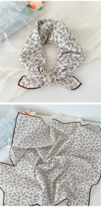 Linen cotton square scarf with botanical print shown tied and laid flat on white fabric