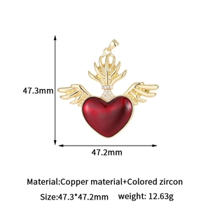 Golden winged red heart pendant with colorful zircons in a professional studio shot