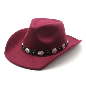 Close-up of burgundy felt fedora hat featuring black leather belt and silver metal rivets