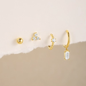 Detail of 925 silver gold-plated U-shaped earrings set with sparkling zircon stones