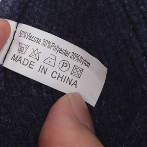 Detail shot of material label showing 50% viscose 30% polyester 20% nylon knit blend