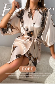 Detail of silk-like champagne leopard print robe showing satin fabric and belted waist