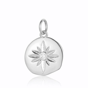 Detail of silver starburst pendant with clear cubic zirconia stone on white background