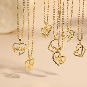 Macro detail of 14K gold plated heart necklaces featuring MOM charms and colorful zircons
