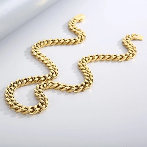 Detailed macro view of heavy gold Cuban link chain with polished beveled edges
