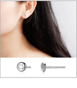 Detail of S999 sterling silver smiley face stud earrings with hallmark on the needle