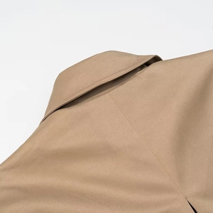Detail shot of khaki trench coat collar and shoulder with high-quality woven fabric texture