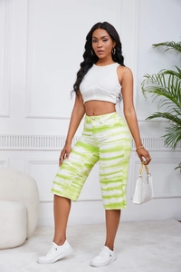 Detailed full body view of a white cropped tank top and green tie-dye shorts set