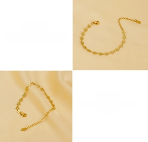 Detail of gold titanium steel bracelet with blue daisy floral links and lobster clasp