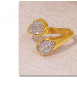 Detail of 18k gold plated titanium ring featuring dual drop-shaped zircon stones