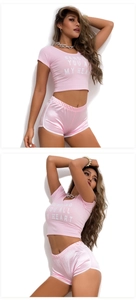 Detailed view of pink cotton T-shirt and satin texture sports shorts on model