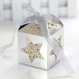 Detail of silver laser-cut star gift box with heart hollow patterns and blue ribbon