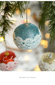 Close-up of 8cm Christmas ball with lace and glitter details on a pine branch