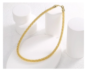 Detail of a gold popcorn chain necklace displayed on minimalist white geometric stone stands