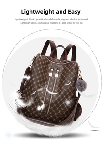 Detail of vintage monogram backpack with dual zippers and a grey plush ball charm
