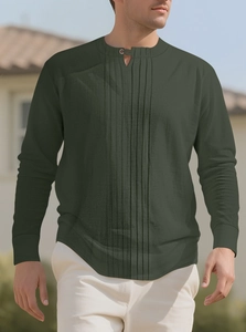 Detail of dark green men's linen shirt featuring pleated texture and buttoned collar