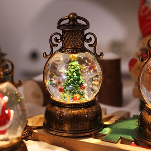 Macro detail of retro bronze Christmas lantern snow globe with tree and LED warm light