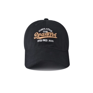 Close-up of Dreams high-quality embroidery detail on black cotton baseball cap