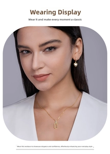 Elegant model wearing a minimalist gold U-shaped necklace and matching heart earrings set