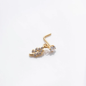 Close-up of gold L-shaped nose stud with zircon leaf pendant and round stone