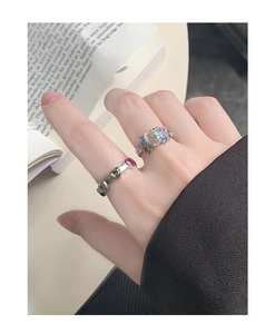 Close-up of S925 silver ring featuring heart-shaped colored zircon and moonstone inlay
