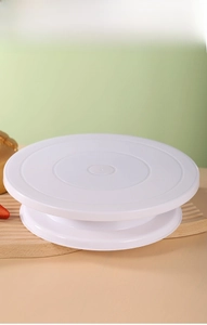 Macro detail of white rotating cake stand with concentric non-slip rings on top