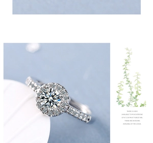 Macro detail of a classic round halo moissanite ring with side accent diamonds
