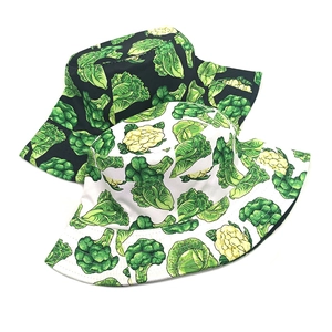 Black and white bucket hats with realistic green broccoli and vegetable pattern prints