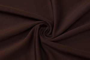 Detailed macro view of brown ribbed knit fabric showing soft texture and elasticity