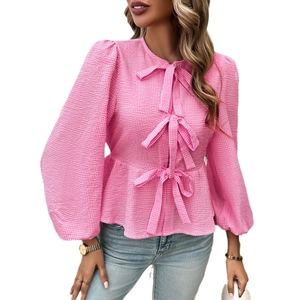 Pink textured peplum top for women with long puff sleeves and three front bow ties