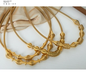Macro shot of gold-plated titanium steel spiral pendant necklace with industrial design