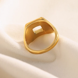 Polished 18K gold plated stainless steel geometric square ring on soft fabric