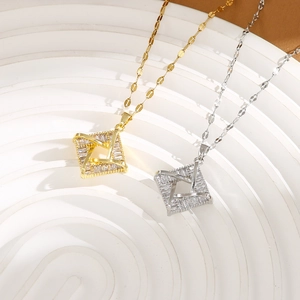 Detailed close-up of gold and silver interlocking square pendants with inlaid zircons