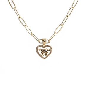 Detailed close-up of golden heart pendant with mama lettering and two children engraving