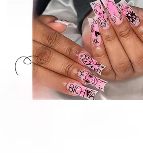 Detailed view of pink gradient rectangular press-on nails with heart and star patterns