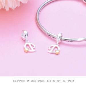 Detailed view of S925 silver bracelet with gold heart letter D charm and engraving