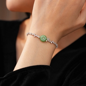 Detailed view of silver zircon bracelet featuring a green chalcedony circular charm