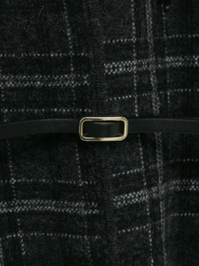 Detail of grey plaid knit fabric with a black leather belt and gold buckle