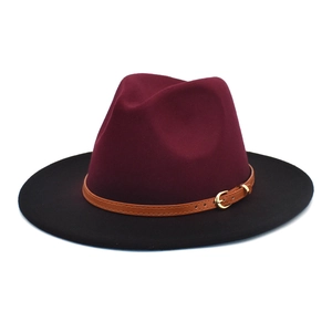 Detail of burgundy and black fedora hat with faux leather band and gold metal buckle