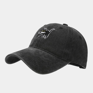 Detail of creative cat with knife embroidery on black washed cotton baseball cap