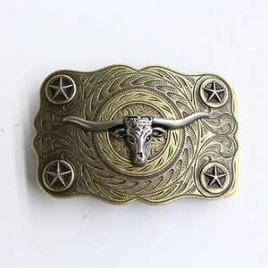 Detailed relief of golden bull skull and western scrollwork on vintage belt buckle