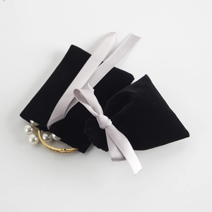 Schwarzer Samt Schmuckbeutel mit grauer Schleife, ideal zur Aufbewahrung von kleinen Accessoires.