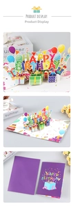 Detail of 3D pop-up birthday card with colorful paper sculpture and purple envelope