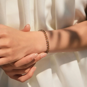 Bohemian 18K gold plated bracelet with sparkling champagne zircons on a model's wrist