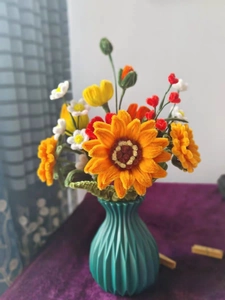 Close-up of DIY sunflower and daisy bouquet in a green spiral textured plastic vase