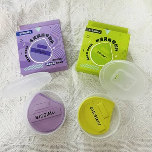 Macro detail of tear-drop makeup sponges in purple and green with clear storage cases